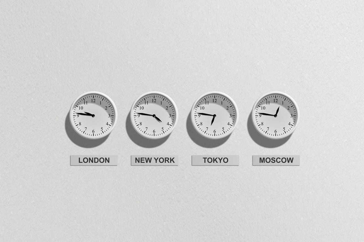 Four wall clocks labelled London, New York, Tokyo and Moscow, each showing a different time